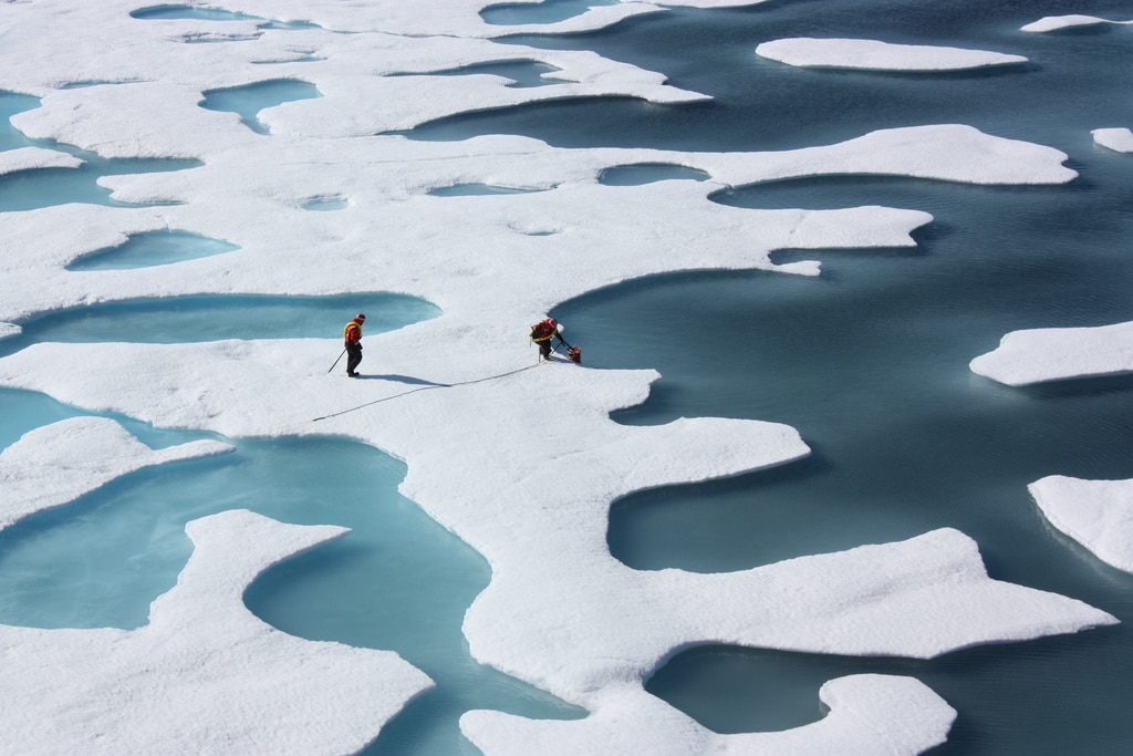 NASA crew on sea ice melt ponds in the Arctic.