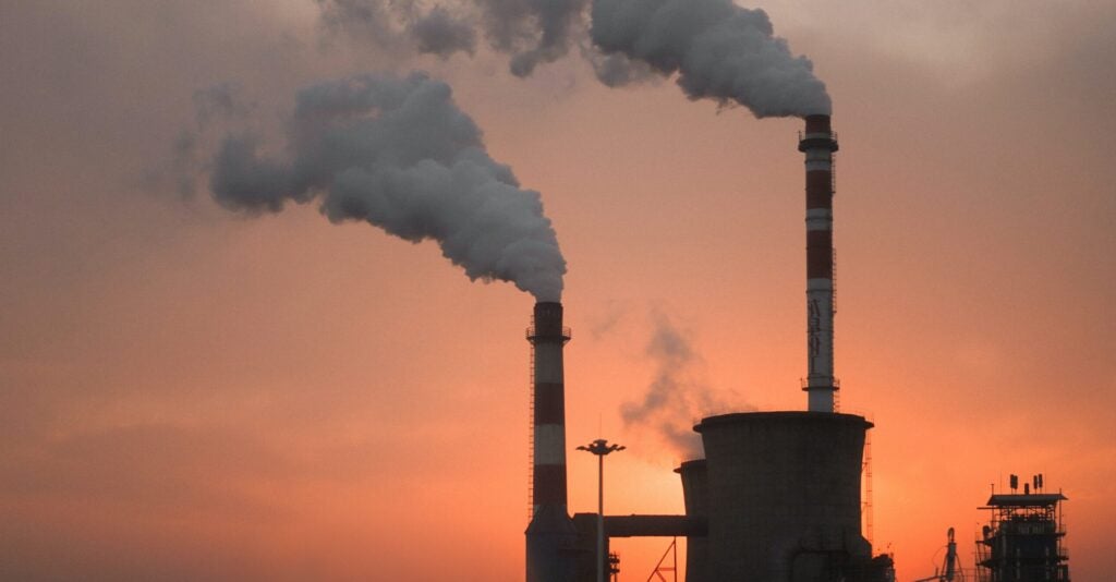 Smoke billowing out of a factory.