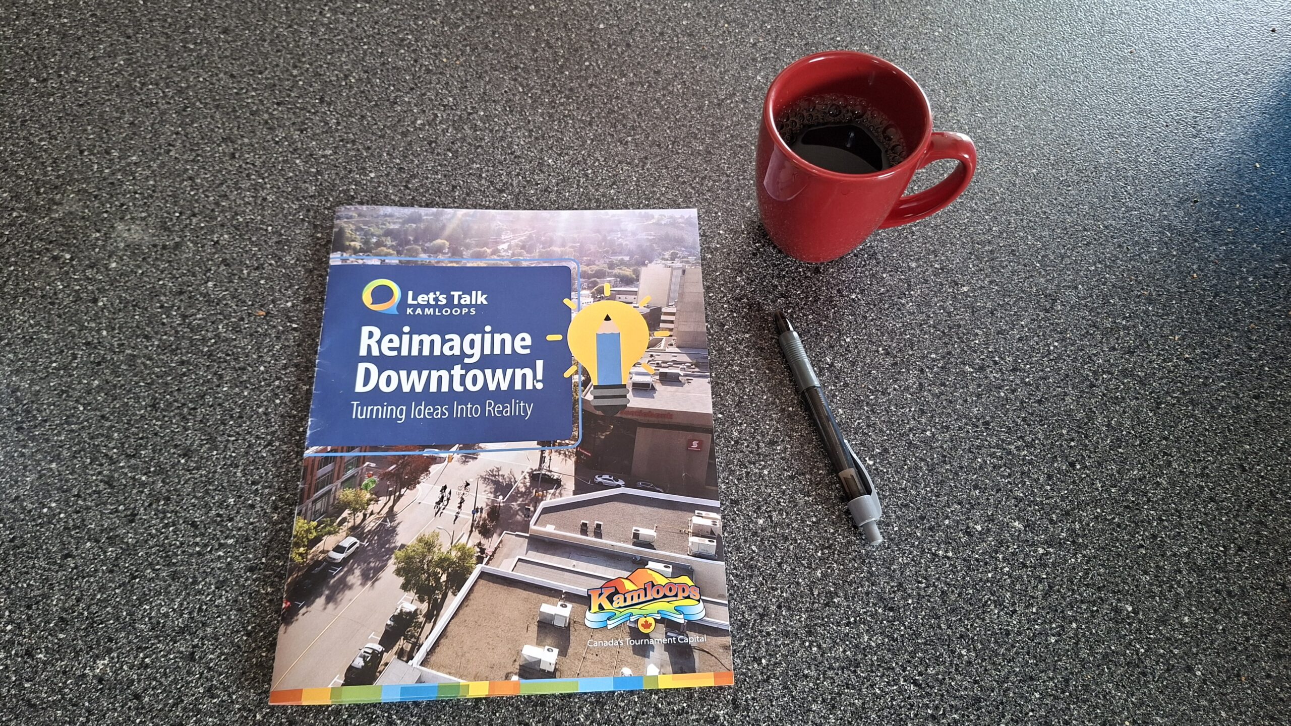 Reimagine Downtown book with mug and pen